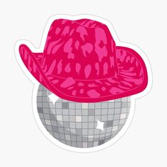 a pink hat sitting on top of a disco ball