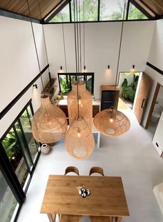 an overhead view of a dining room and living room area with wood table and chairs