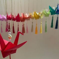 an origami crane hanging from a chain