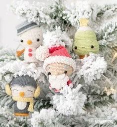 crocheted christmas ornaments are hanging from a white tree with snowflakes on it