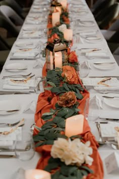 a long table is set with candles and flowers on it for an elegant dinner party