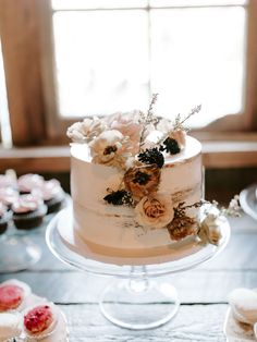 a wedding cake with flowers on top