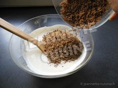 a person mixing ingredients in a bowl with a wooden spoon