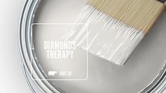 a paint can with a brush in it and the words diamonds therapy painted on it