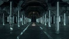 an empty room with columns and lights in it