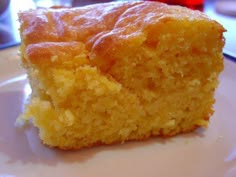 a piece of cornbread sitting on top of a white plate