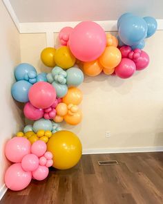 there are many balloons in the air on the floor next to the wall and stairs