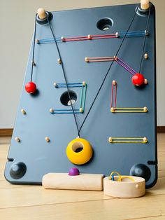 a play table with toys and pegs on it