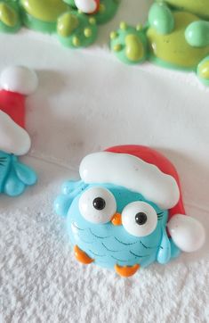 two blue and white owl figurines with santa hats