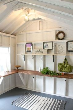 a room filled with lots of shelves and pictures on the wall next to a rug