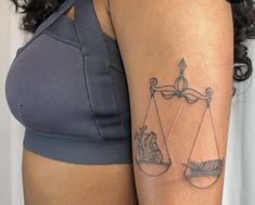 a woman with a tattoo on her arm has an hour and hour scale tattooed on her arm