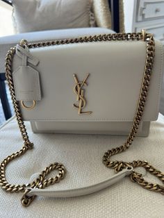 Very good condition Authentic Saint Laurent medium Sunset bag in off white with antique gold hardware. Fits a lot and is perfect for everyday wear or going out. Neutral color goes with every outfit. Very versatile, can be worn as shoulder bag or crossbody bag. Neutral Color, White Bag, Cloth Bags, Ysl Bag, Neutral Colors, Smooth Leather, Antique Gold, Gold Hardware, Bags Handbags