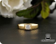 a diamond ring sitting on top of a table next to a white flower with the words luminous luxury written below it