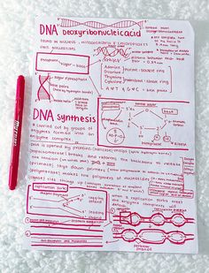 a red pen sitting on top of a piece of paper next to a marker and some type of diagram