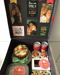 an open box with some food inside of it and pictures on the wall behind it