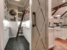 an open door leading to a kitchen with white cabinets