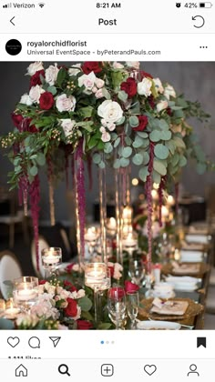 an image of a table setting with flowers and candles on it, including roses in tall glass vases