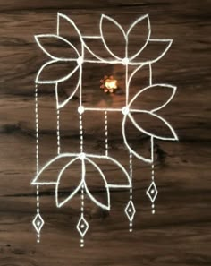 a wooden table topped with a drawing of flowers and leaves on it's side