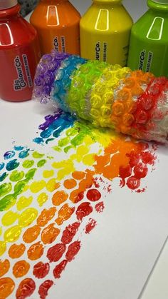 there are many different colors of crayons on the table next to each other