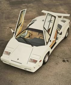 a white sports car with its doors open