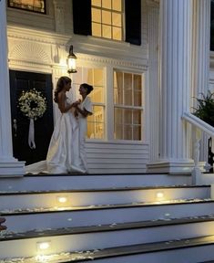 the bride and groom are walking down the stairs