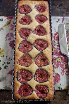 a cake that has been decorated with strawberries in the shape of hearts and is ready to be eaten