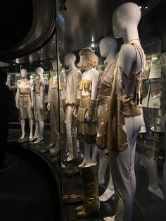 mannequins dressed in gold and white outfits