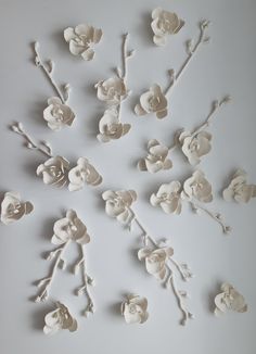 white flowers are arranged on a gray surface