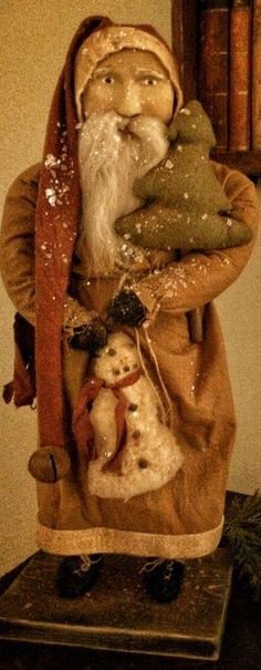 an old fashioned christmas decoration with a gnome and snowman on it's back