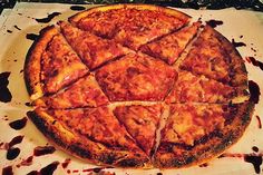 a large pizza sitting on top of a wooden cutting board