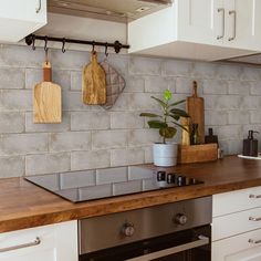 a kitchen counter with cutting boards on the wall next to an oven and dishwasher