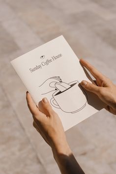 a person holding up a book with a drawing on it's front cover that reads, sunday coffee house