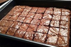 a pan filled with brownies sitting on top of a table