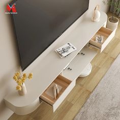 a flat screen tv mounted to the side of a wall next to a white shelf