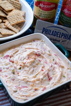 dip and crackers on a picnic table