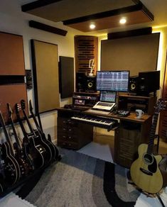 a recording studio with guitars, keyboards and other musical equipment in it's display area