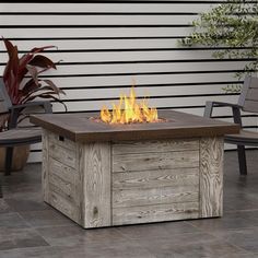 a fire pit sitting on top of a wooden table