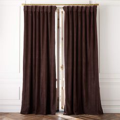 the curtains are closed and ready to be hung in front of an open door with wood floors