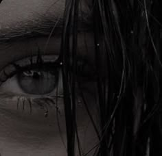 a woman's eye with long black hair