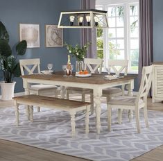 a dining room table and chairs in front of a window with blue walls on the other side