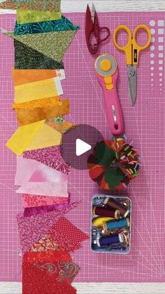 scissors, tape and other crafting supplies laid out on a piece of pink paper