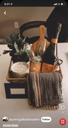 a basket filled with wine bottles and other items on top of a white countertop