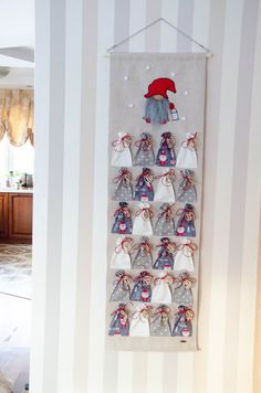 a christmas decoration hanging on the wall in a room with striped walls and flooring