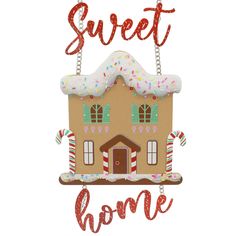 a gingerbread house ornament with the words sweet home in red and white