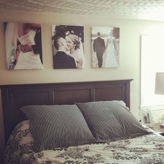 a bed with two pictures on the wall above it