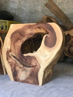 three pieces of wood sitting on top of a white table next to other wooden objects