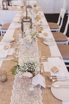 a long table set with place settings and silverware for guests to sit down at