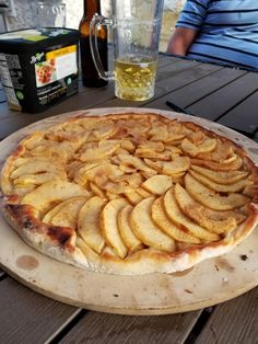 a pizza sitting on top of a wooden table