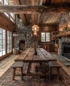 a rustic dining room with stone fireplace and wooden table