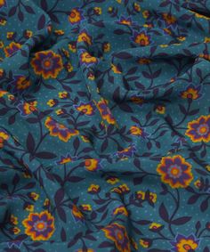 the fabric is blue with yellow and purple flowers on it